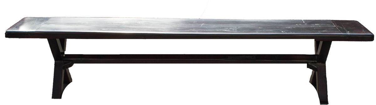 Bench, a long seat on crossed legs made from recycled red jarrah wood in Zimbabwe, with a dark finish