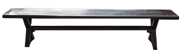 Bench, a long seat on crossed legs made from recycled red jarrah wood in Zimbabwe, with a dark finish