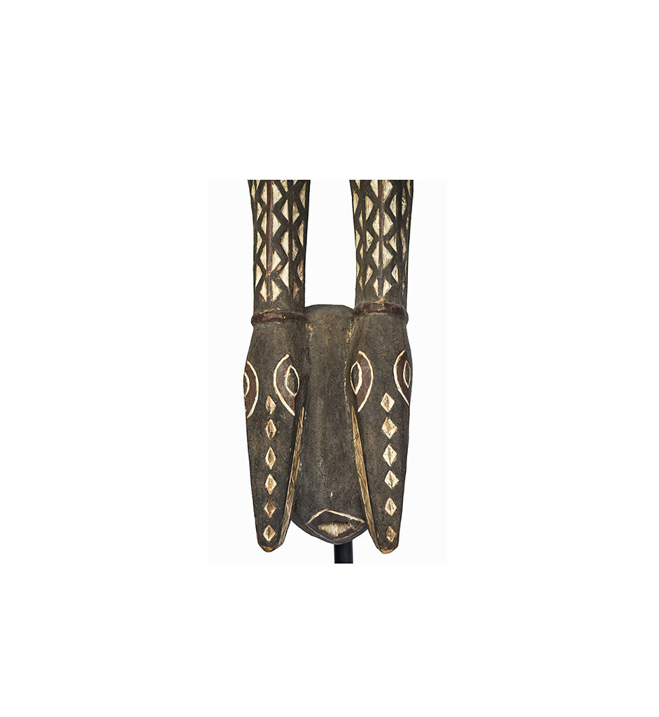 Mask, a Mossi antelope mask carved from wood in Burkina Faso, close-up of the face with white diamonds and ringed eyes