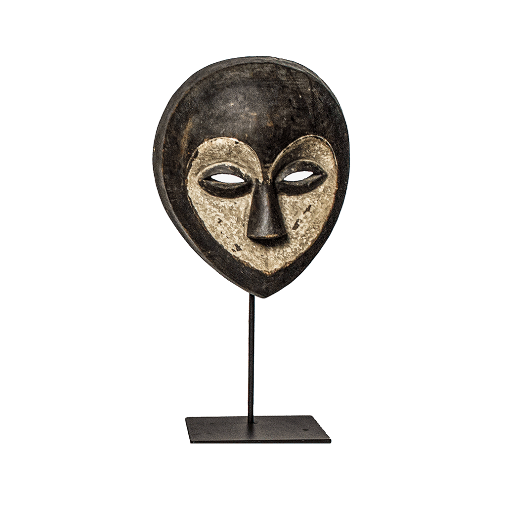 Kwele Mask, a Kwele mask carved from wood in Cameroon, with a white heart-shaped face and narrow eyes, on a metal stand