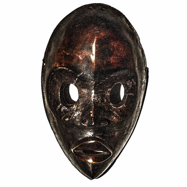 Dan Mask, a dark brown racing mask with round eye holes and full lips, carved from wood by the Dan people of Ivory Coast