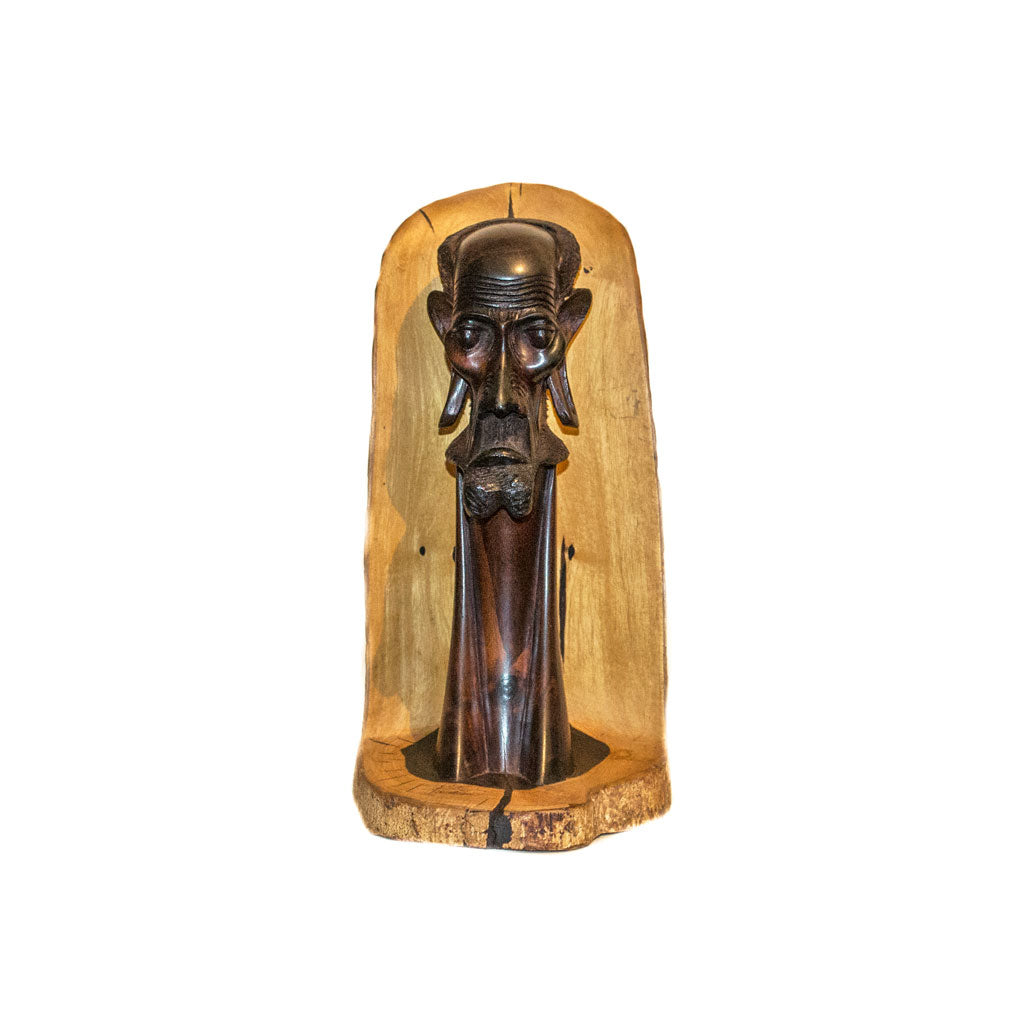 Masaai Tribe, a Masaai elder's head carved from ebony wood in Kenya, the dark face set against the pale outer wood
