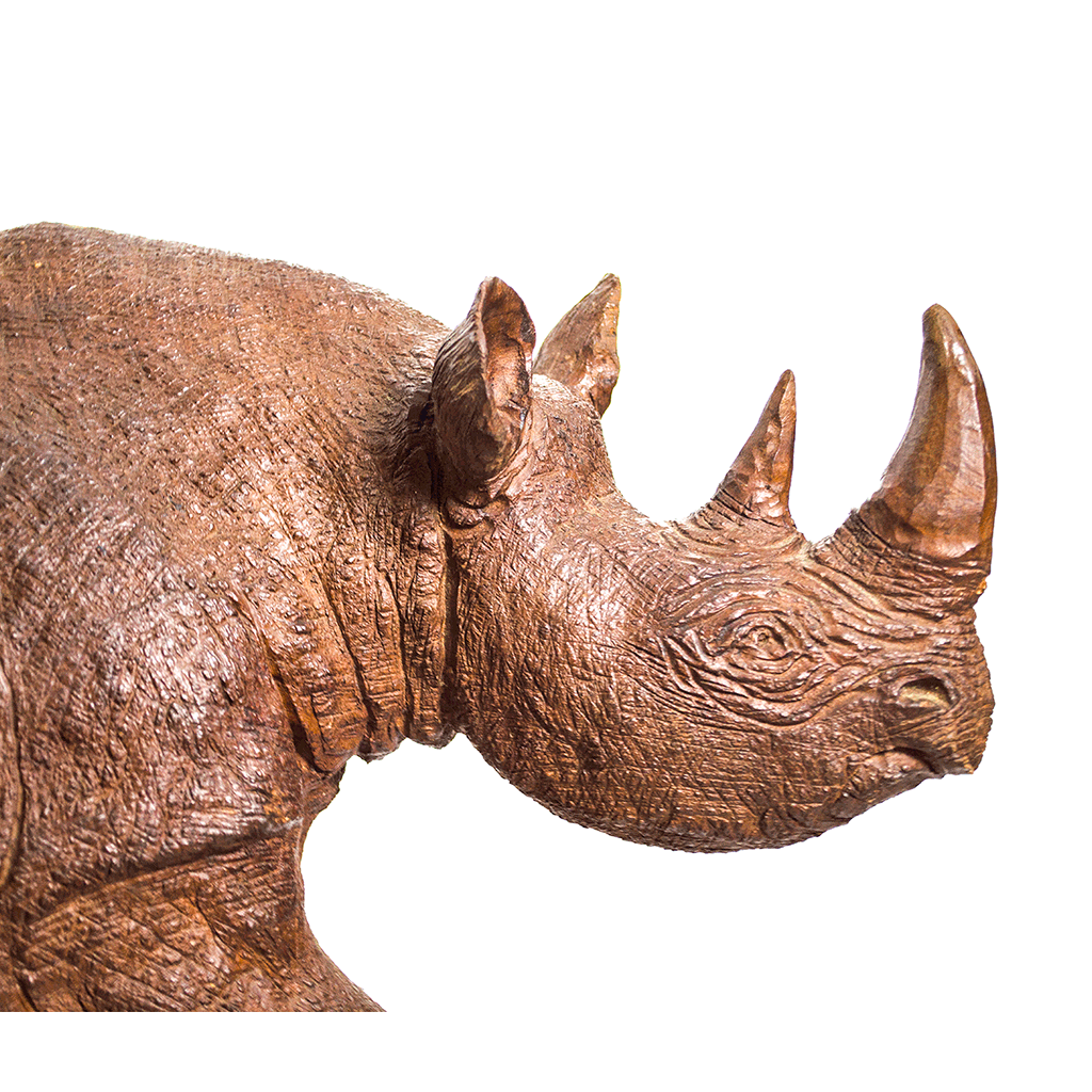 Rhino, a rhinoceros carved from one piece of wood in Kenya, with rough cut skin, raised ears and two horns