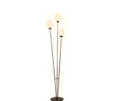 Full view of the Three Egg Ostrich Egg Lamp with three lit eggs on thin metal stems and a round base