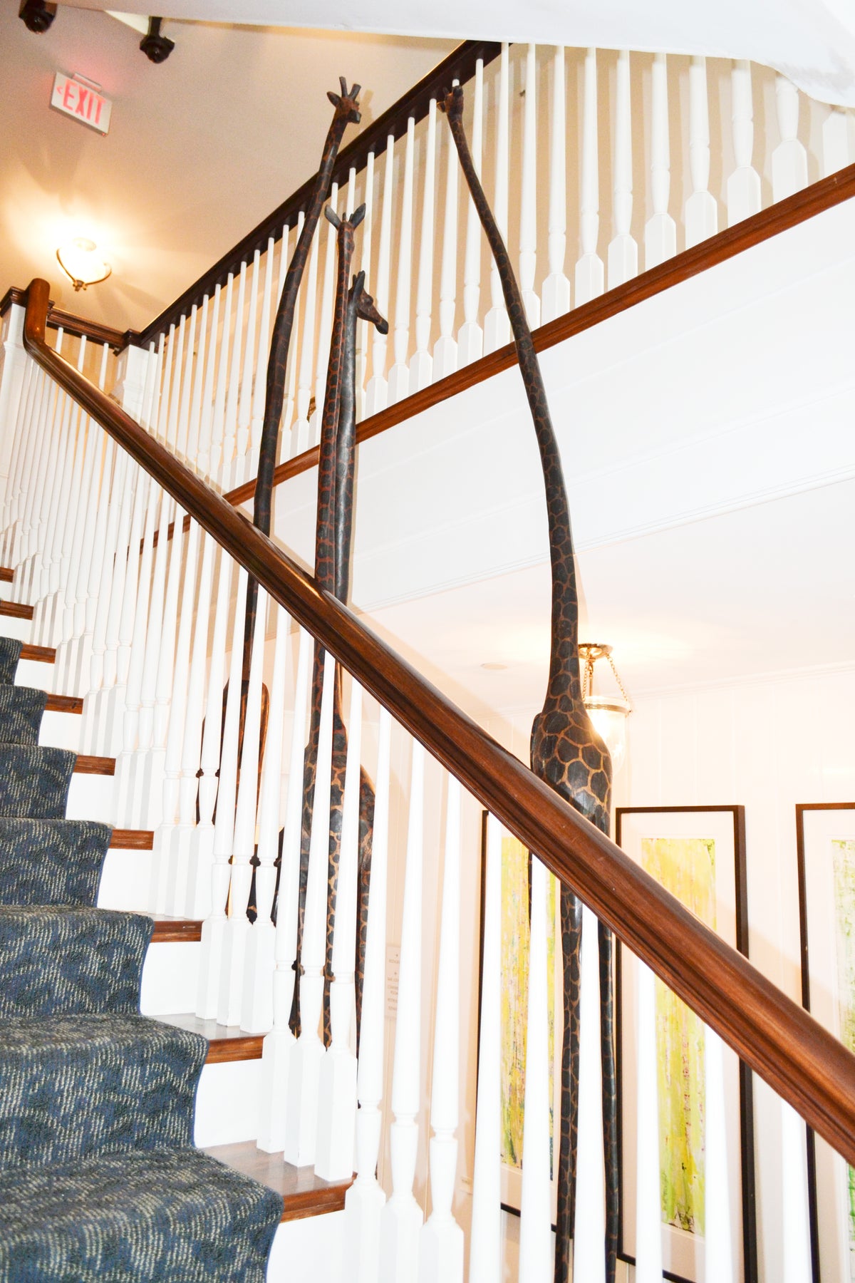 Giraffes beside a staircase