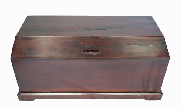 Trunk, a storage chest made from recycled red jarrah wood in Zimbabwe, with a sloped lid and a wooden handle