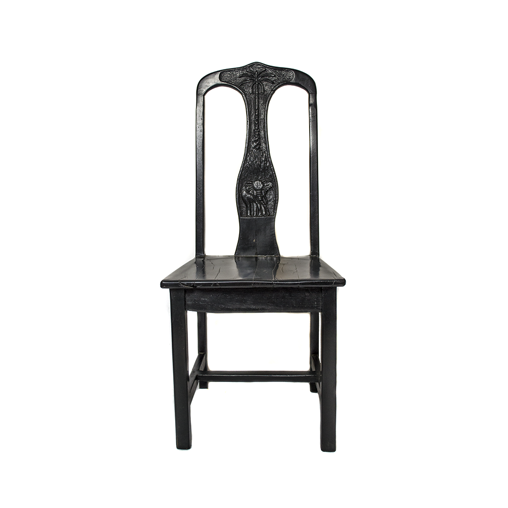Chair made from recycled black jarrah wood in Zimbabwe, with an elephant and palm tree carved into the back