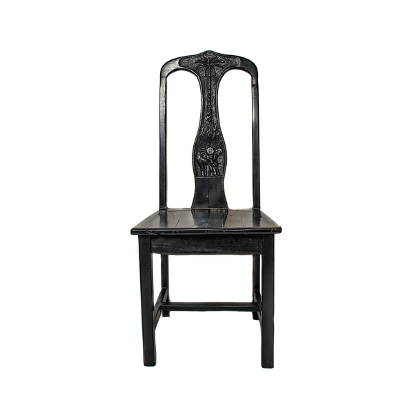 Chair made from recycled black jarrah wood in Zimbabwe, with an elephant and palm tree carved into the back