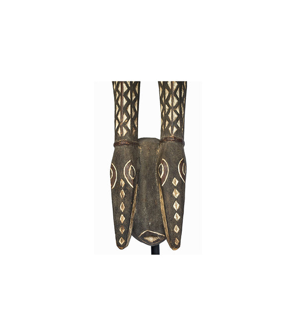 Mask, a Mossi antelope mask carved from wood in Burkina Faso, close-up of the face with white diamonds and ringed eyes