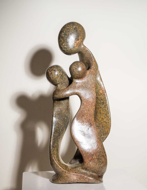 Family of Three by Agrippa Ndongwe, a Shona sculpture of parents and a child carved from green serpentine stone in Zimbabwe